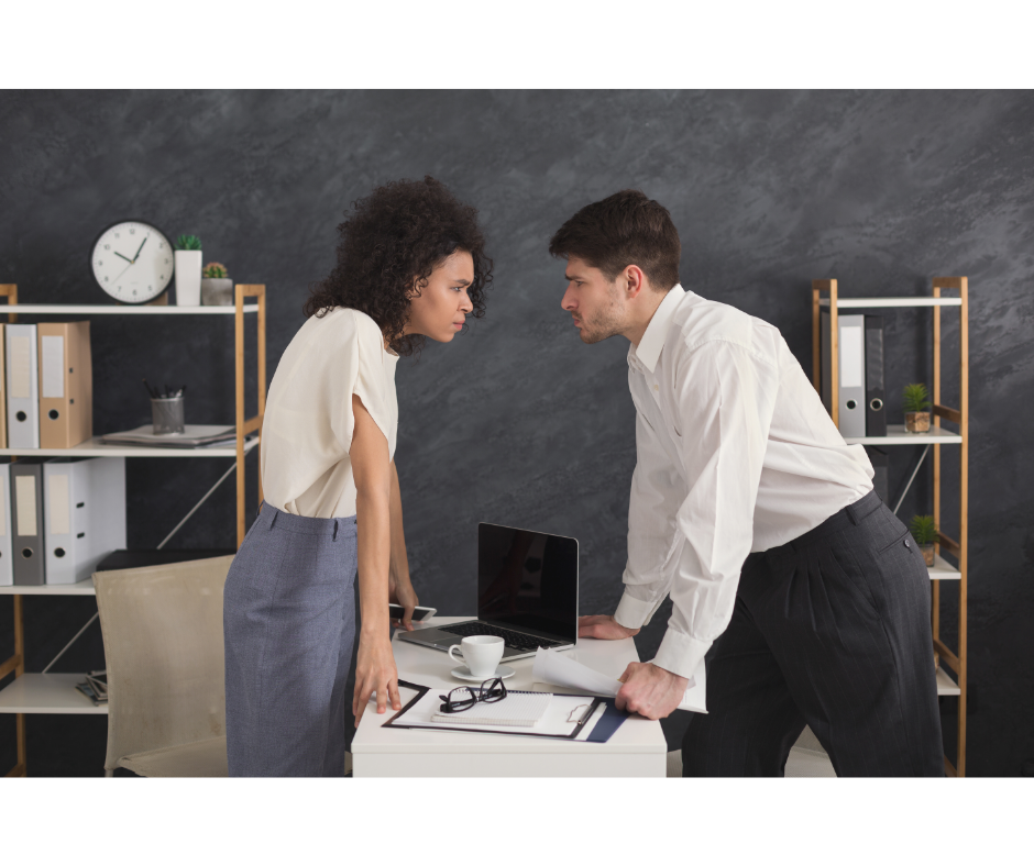 Two employees at work who need to learn conflict resolution techniques. A man and a woman staring each other down in a conflict.